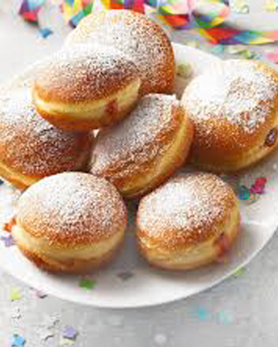 Freshly prepared Berliners filled with jam.