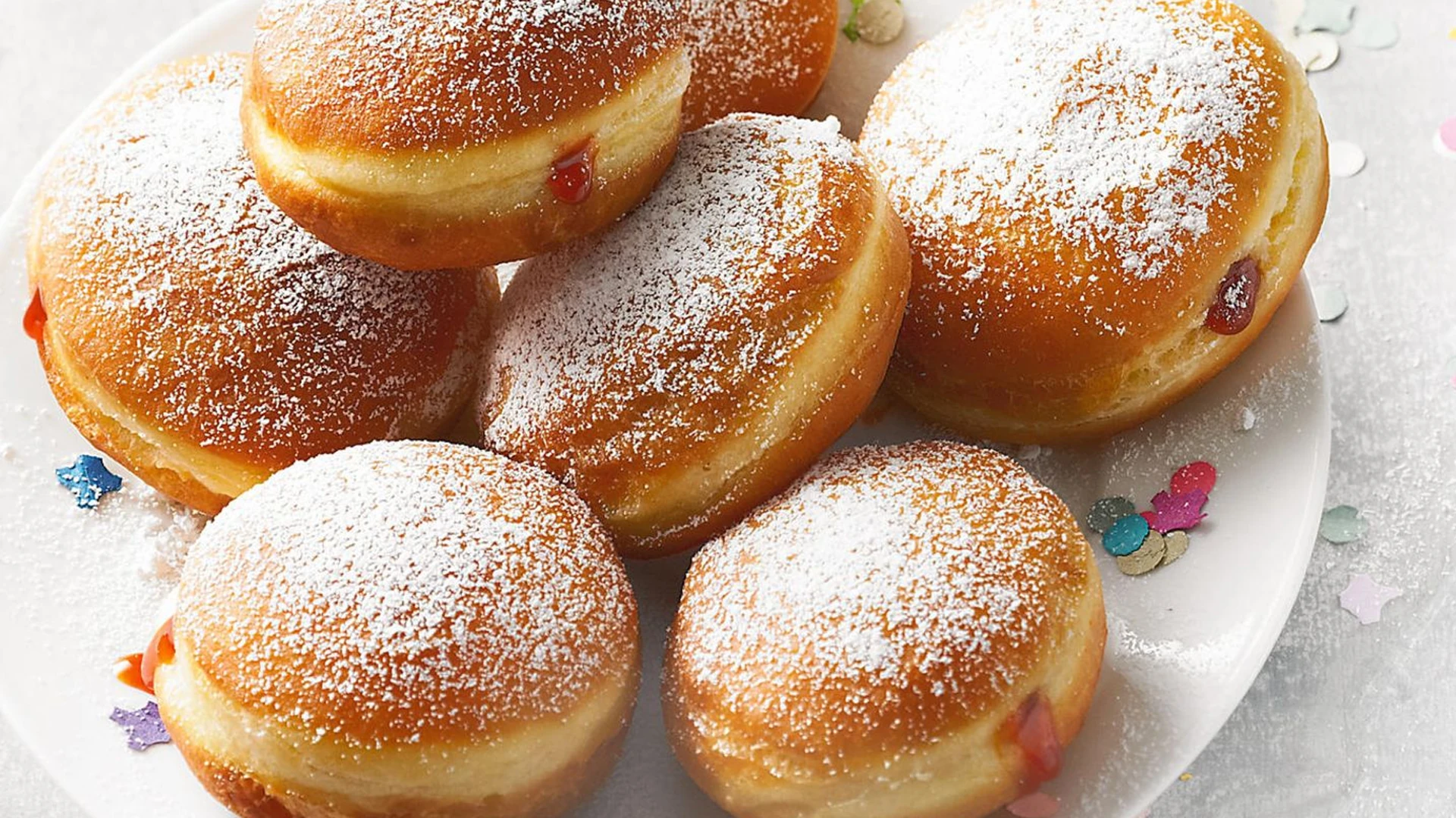 Freshly prepared Berliners filled with jam.